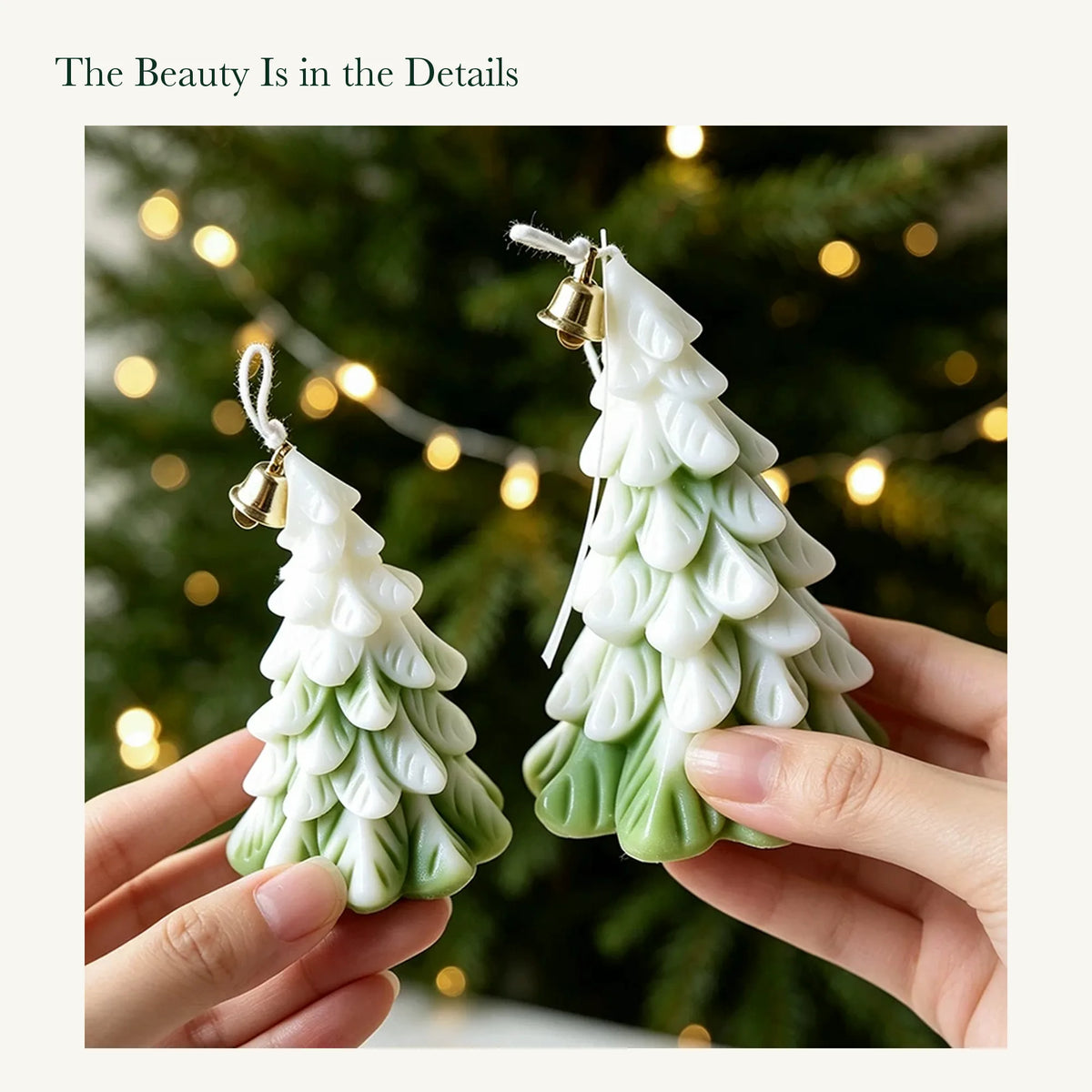 Hands holding small and large olive green and white tree candles with sculpted branches and original gold-colored bells.
