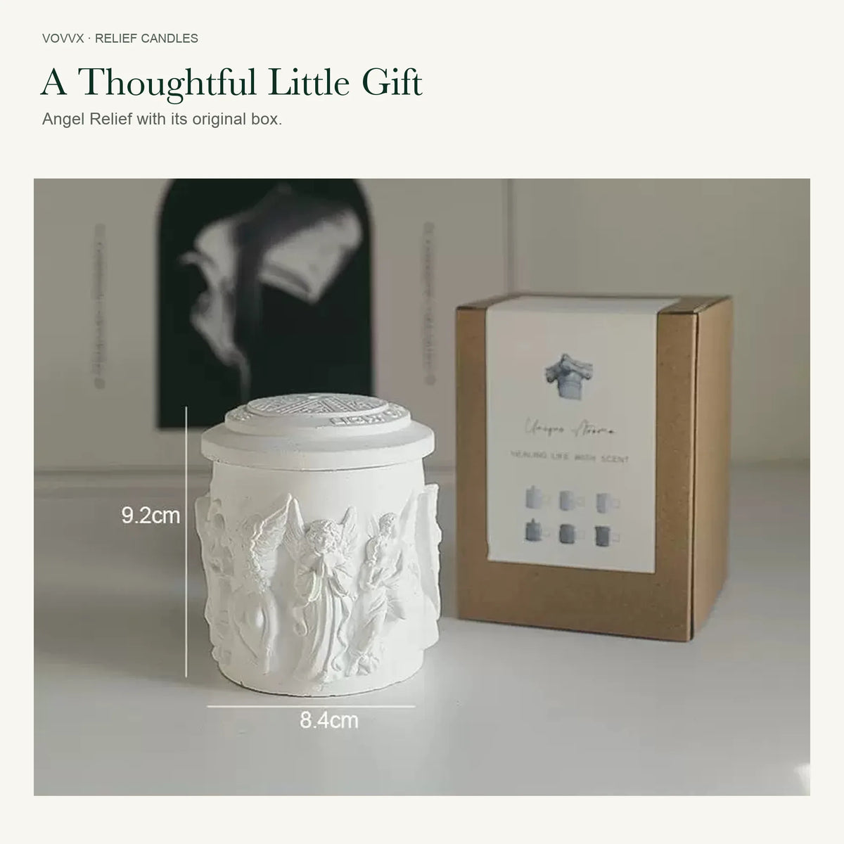 Original white Angel Relief candle with patterned lid beside its kraft box, showing 9.2 cm height and 8.4 cm width markings.