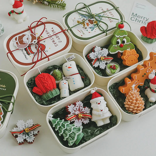 Original Christmas candle gift set collection with open boxes showing tree, Santa, snowman, mitten, gingerbread, pinecone, and snowflake combinations.