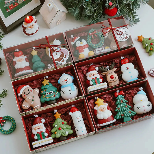 Christmas candle gift set collection with original boxes, red tissue lining, cords, and festive tags.