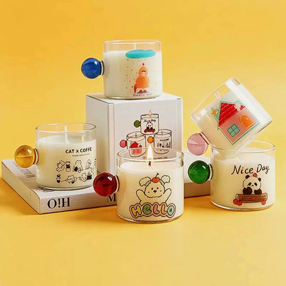 Five original illustrated glass candle styles with colorful round handles and original packaging on a yellow background.