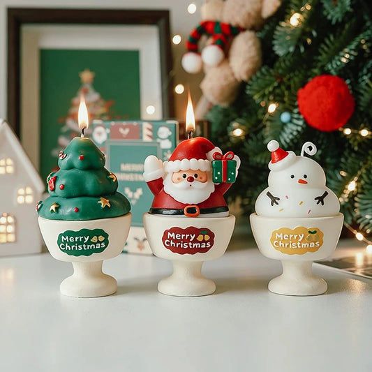 Christmas tree, Santa, and snowman candles in original footed Merry Christmas cups in a festive home display.