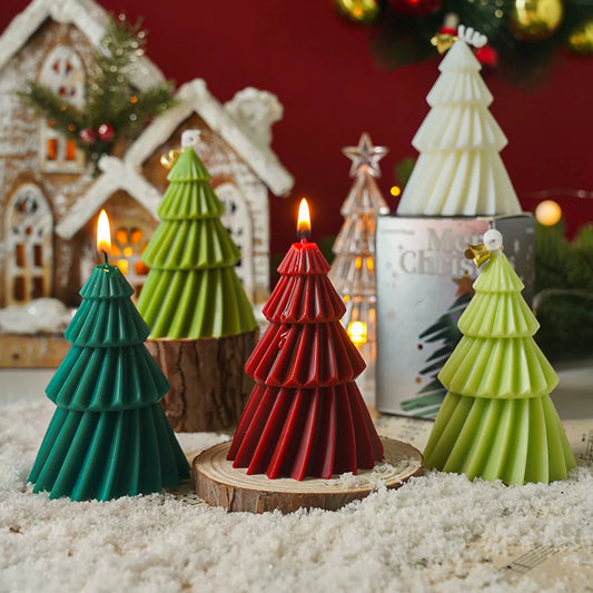 Original pleated Christmas tree candles in teal, red, olive green, light green and white in a holiday display.