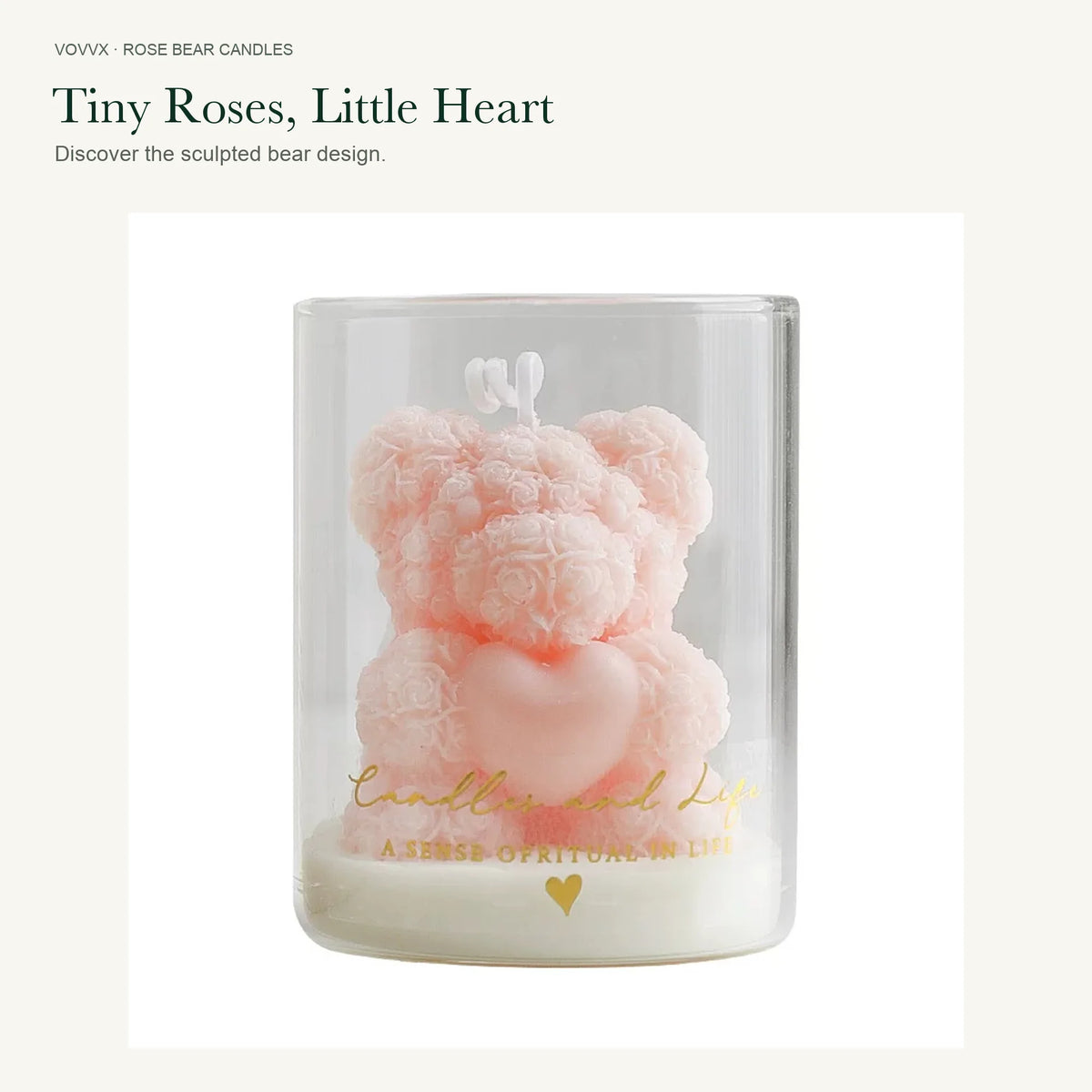 Close-up of the original soft pink rose-bear candle holding a heart in its clear gold-printed glass.