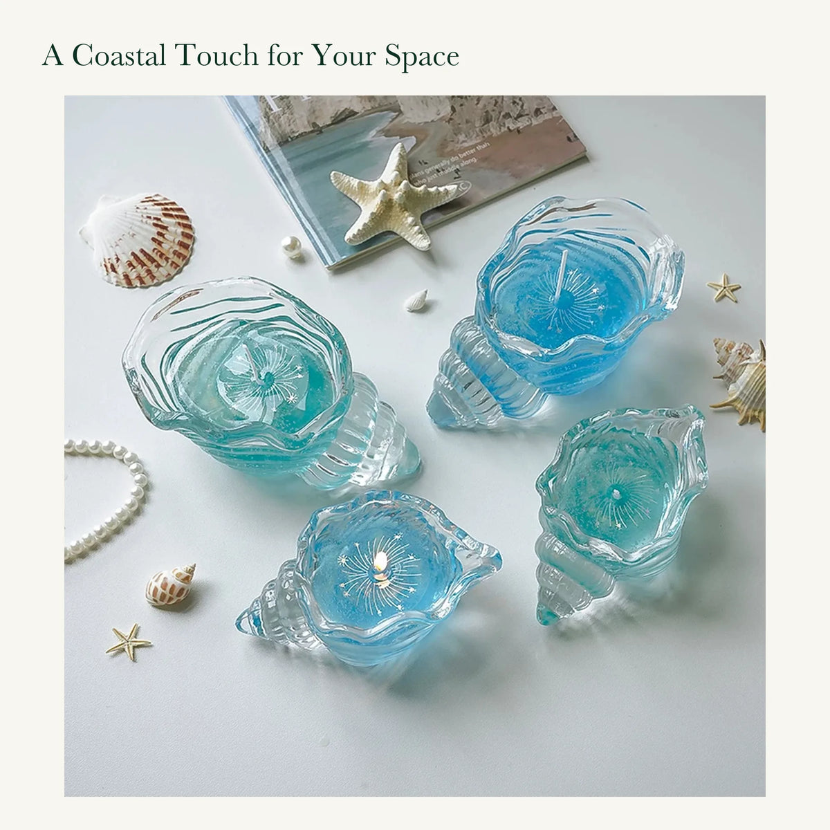 Blue and aqua shell-shaped glass candles photographed in natural light with decorative shells and pearls.